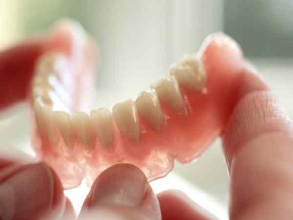 Nhìn thấy răng giả có ý nghĩa gì, con số nào đẹp?